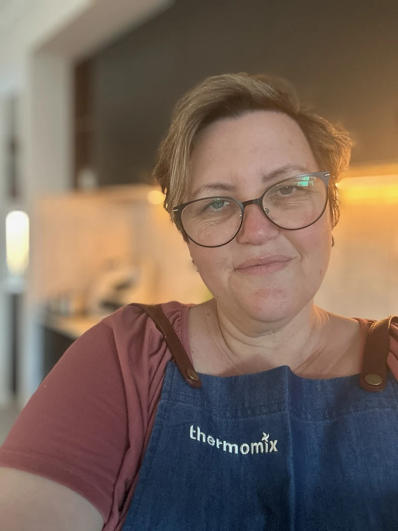 Belinda Tucker — smiling, wearing her Thermomix apron in the kitchen